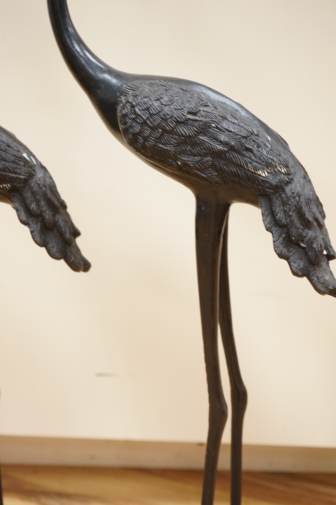 A pair of patinated bronze cranes, 62cm